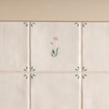 Off-white ceramic spring emma tile 13 x 13cm with delicate hand-painted pink and green floral motifs