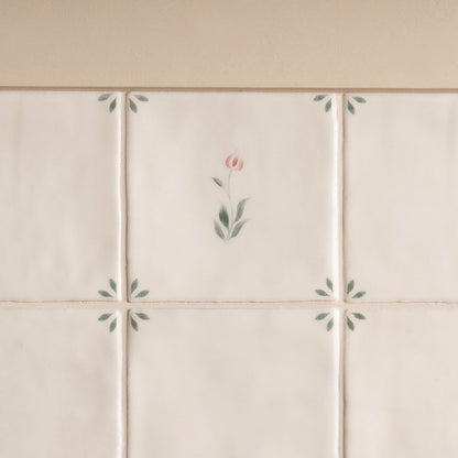 Off-white ceramic spring emma tile 13 x 13cm with delicate hand-painted pink and green floral motifs
