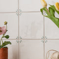 White ceramic tiles spring may 13 x 13cm with subtle green leaf motifs at each corner for decorative use