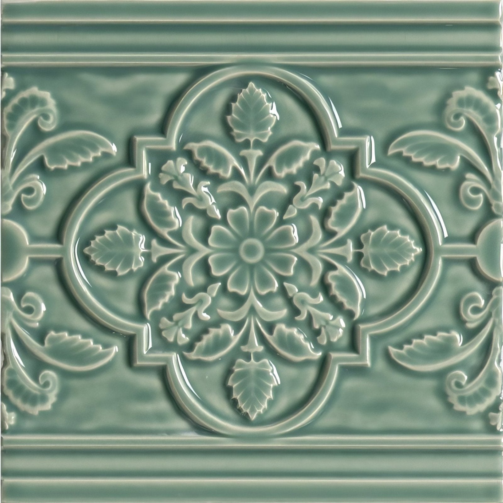 A glossy sage green ceramic tile st james on jade breeze with intricate raised floral and leaf pattern in quatrefoil design