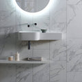 Statuarietto Honed 60x30cm white marble-effect tiles with a wall-mounted sink and chrome tap