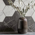 Statuarietto Honed Hexagon Mosaic white marble hexagonal mosaic with a dark brown vase of olive branches
