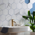 Statuario nuovo honed hexagon mosaic white marble effect bathroom tiles with gray veining and blue grout lines
