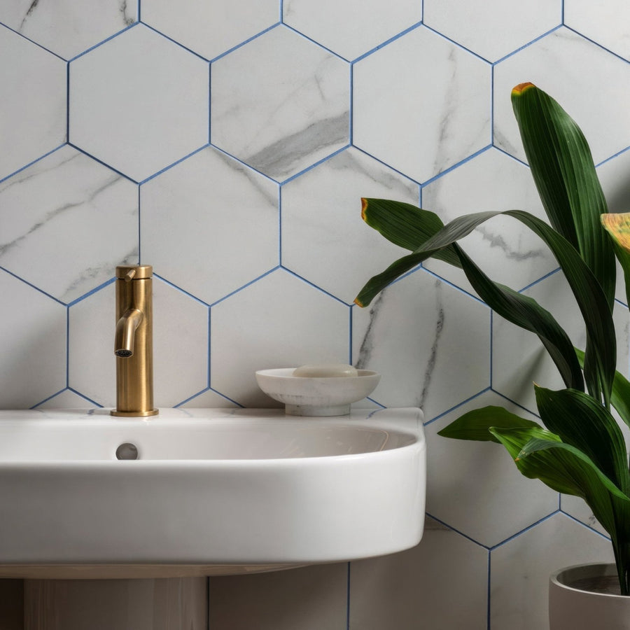 Statuario Nuovo Honed Hexagon Mosaic white marble hexagonal mosaic with a white sink and gold tap