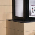 Beige textured stone flat quarry tiles 148x148x9mm with dark brown window sill and frame in a natural stone finish