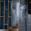 Dark blue textured stone glaze ceramic atlantic gloss brick tiles with gold-toned grout in vertical pattern