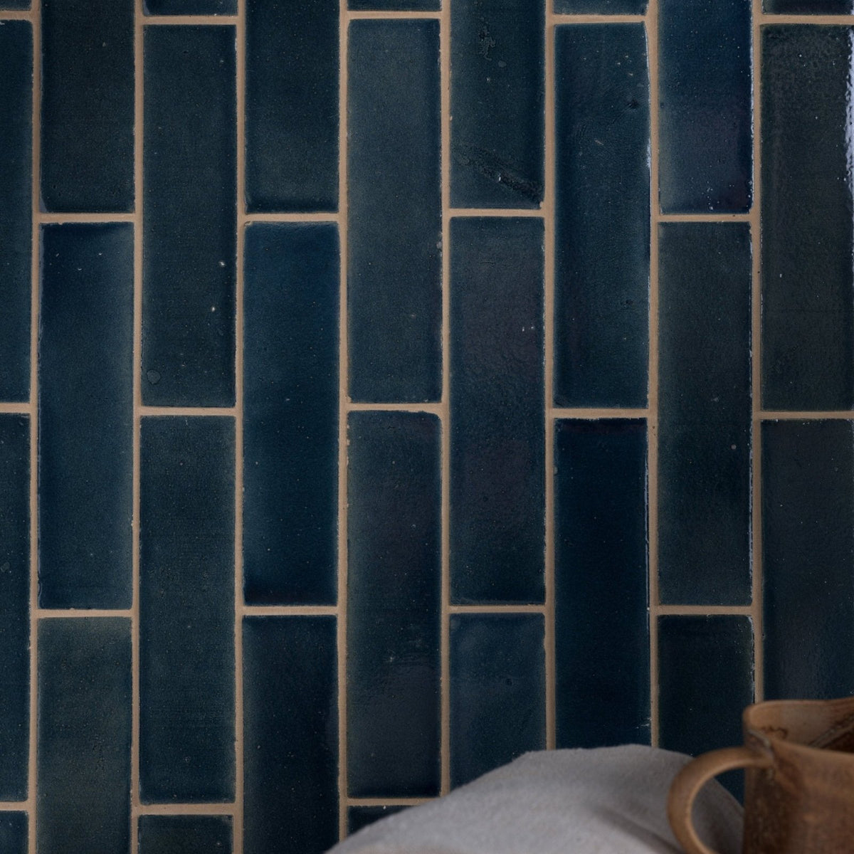 Dark blue rectangular stone glaze ceramic atlantic gloss brick tiles with light beige grout in vertical brick pattern