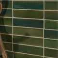 Stone glaze ceramic british green gloss brick tiles with glossy finish and subtle shade variations in a grid pattern