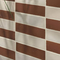 Brown and white rectangular stone glaze ceramic chalkstone gloss brick tiles arranged in staggered brick pattern