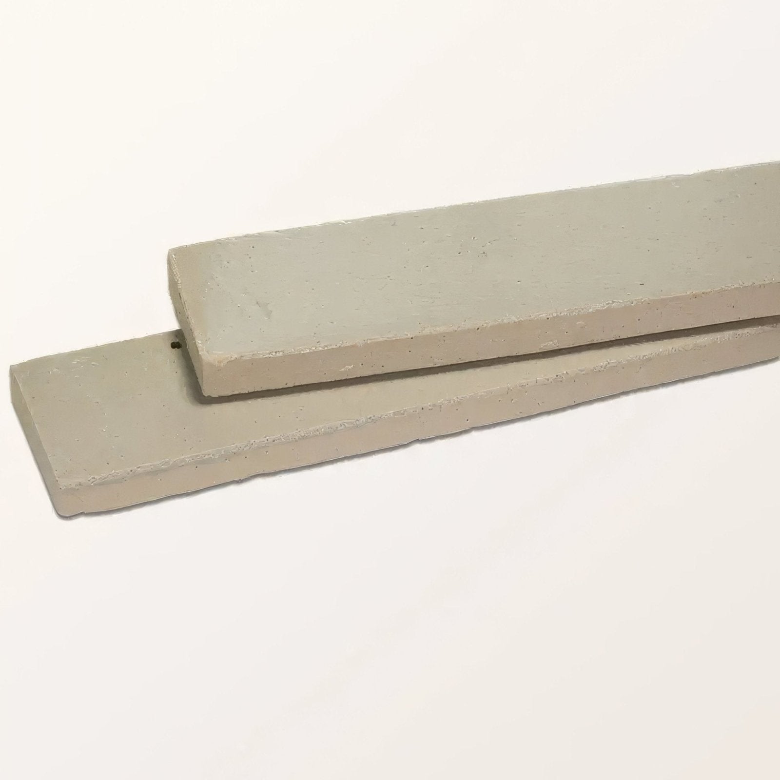 Two light gray rectangular concrete slabs with rough texture and uneven edges stone glaze ceramic chambray gloss brick