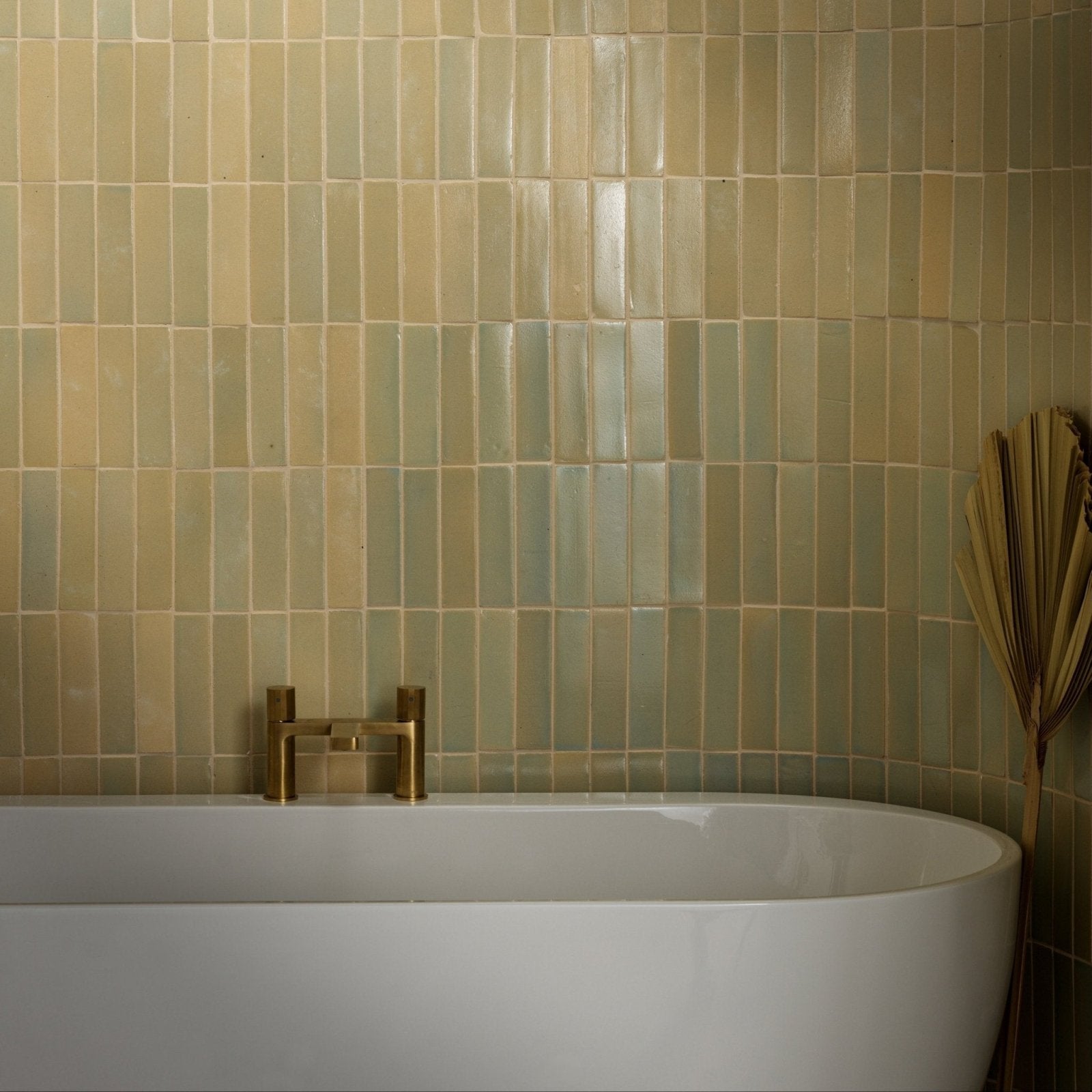 Beige rectangular stone glaze ceramic chambray gloss brick tiles with glossy finish on wall behind white bathtub
