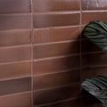 Brown rectangular stone glaze ceramic cola gloss brick tiles with a glossy slightly textured finish on the wall