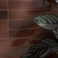 Dark brown glossy rectangular stone glaze ceramic cola gloss brick tiles arranged in a brick-like wall pattern