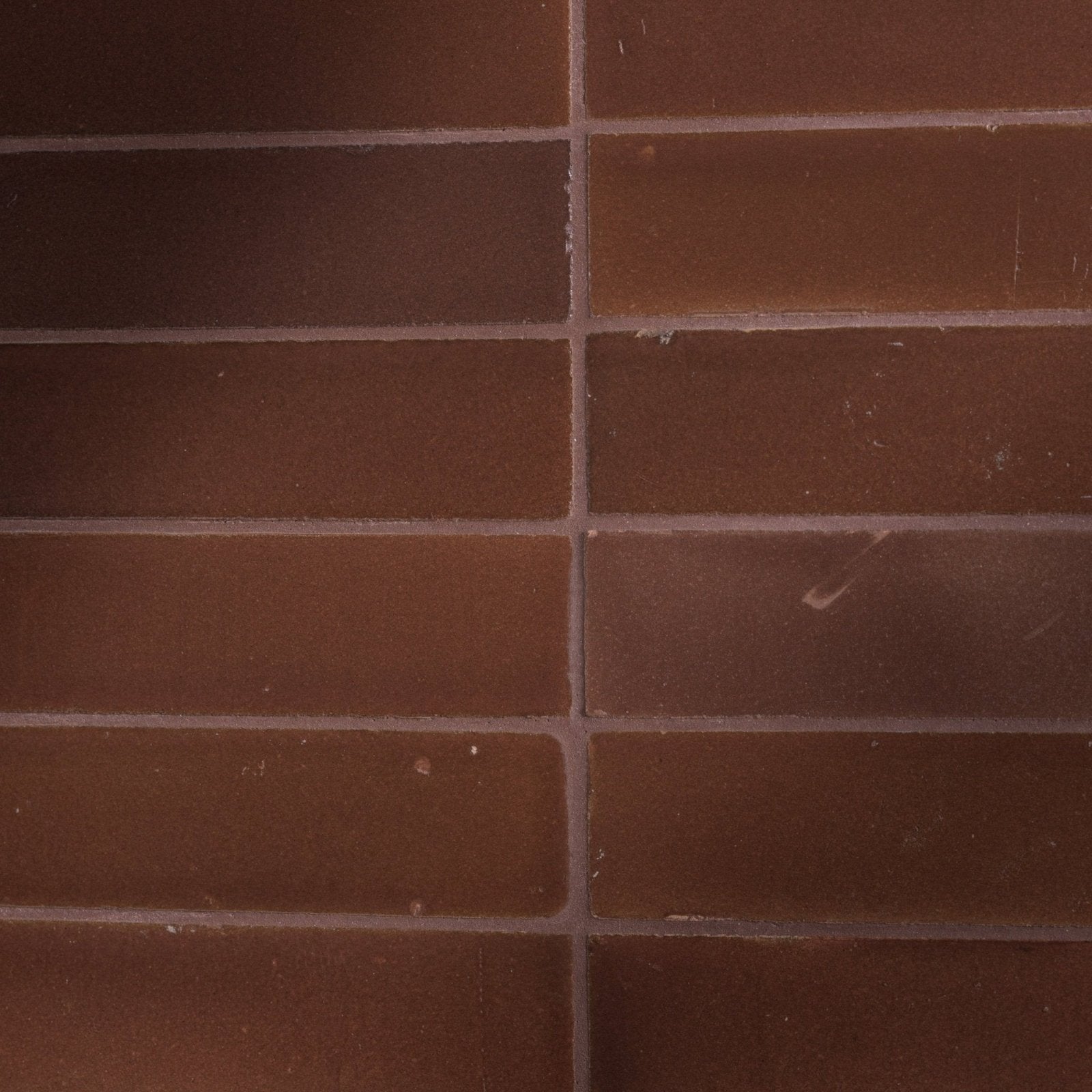 Brown rectangular stone glaze ceramic cola gloss brick tiles with subtle tone variations and minor surface imperfections