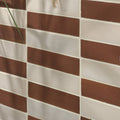 Brown and white rectangular stone glaze ceramic cola gloss brick tiles arranged in a staggered pattern