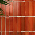 Terracotta-colored stone glaze ceramic imperial red gloss brick tiles with a matte slightly textured finish arranged vertically