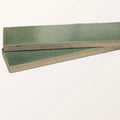 Two rectangular stone glaze ceramic menthol gloss brick tiles with matte sage green glaze and beige ceramic edges