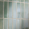 Green rectangular glass tiles with textured frosted finish arranged in grid pattern stone glaze ceramic menthol gloss brick