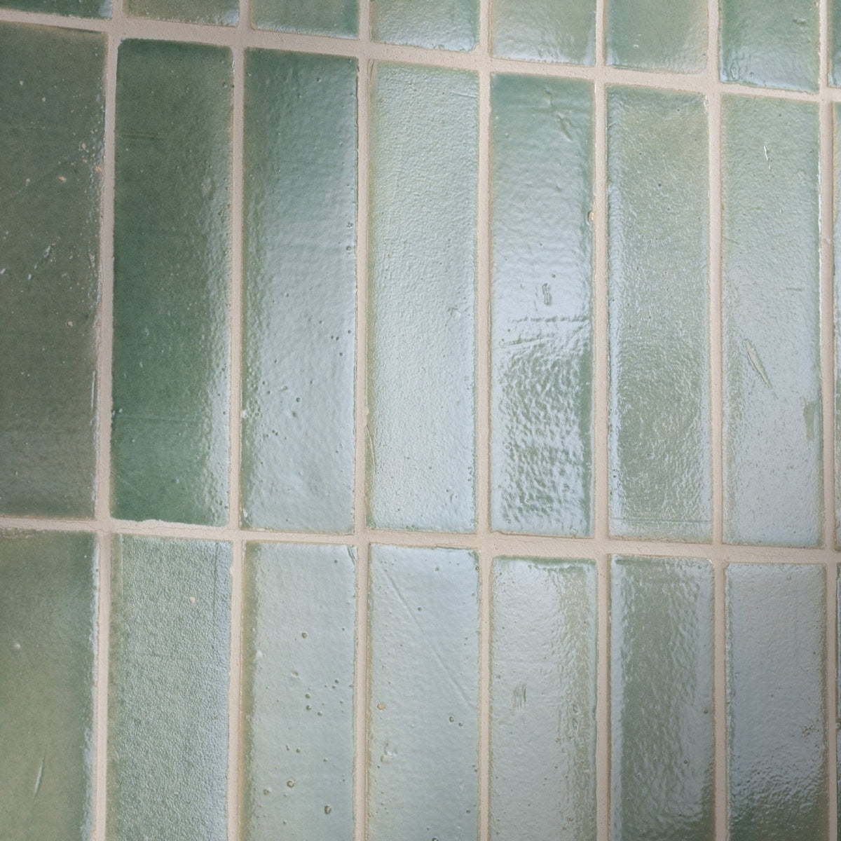 Green rectangular glass tiles with textured frosted finish arranged in grid pattern stone glaze ceramic menthol gloss brick