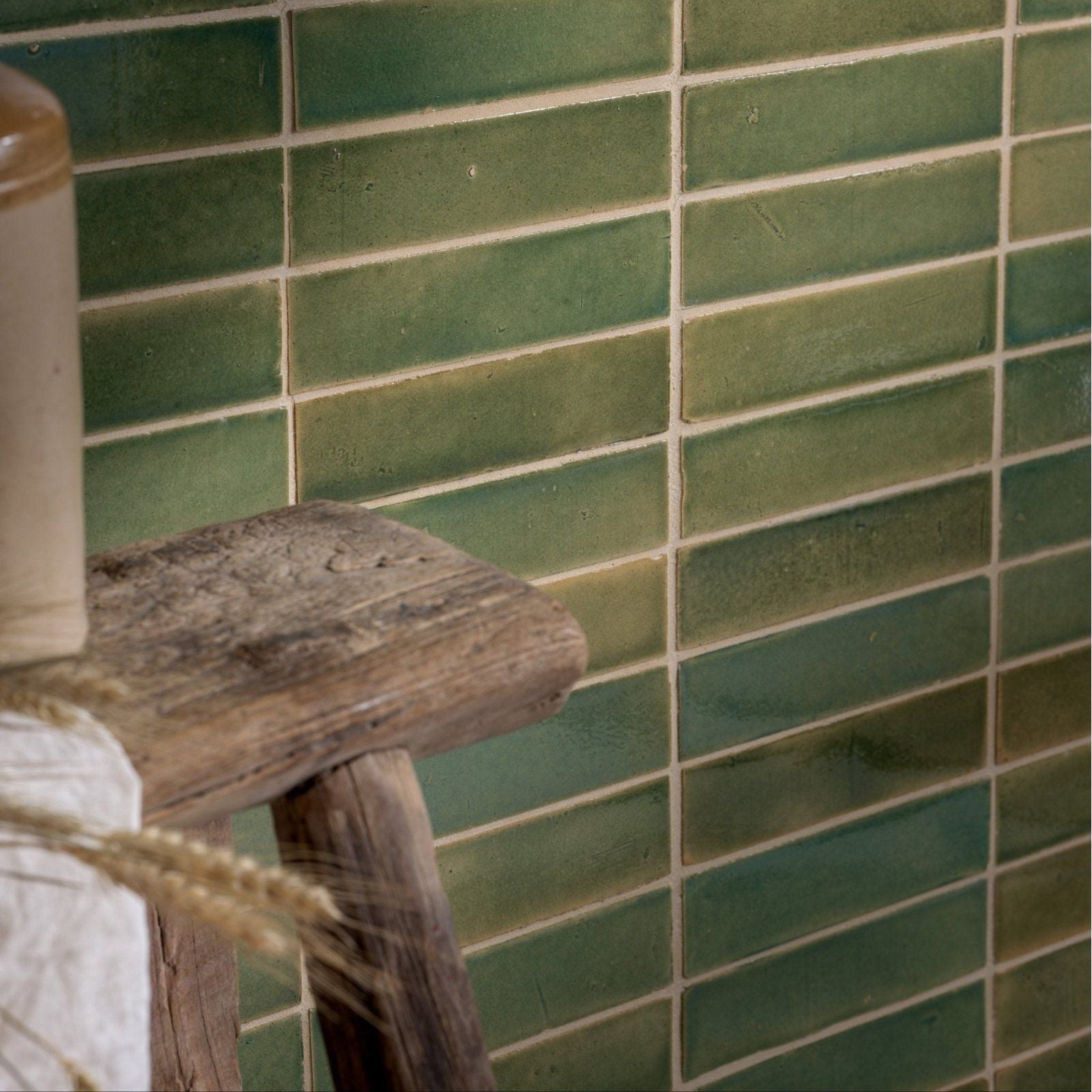 Green rectangular ceramic tiles with a rustic glazed finish arranged in a running bond pattern stone glaze ceramic olive leaf gloss brick