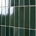 Dark green glossy stone glaze ceramic petrol green gloss brick tiles with a slightly textured rectangular design in grid pattern