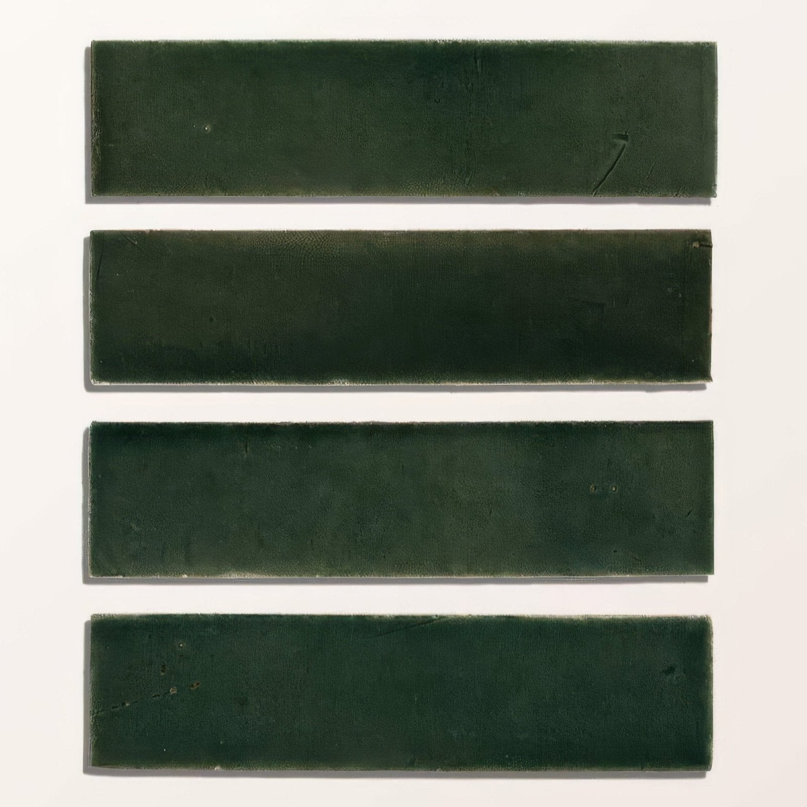 Four rectangular dark green stone glaze ceramic petrol green gloss brick tiles arranged vertically