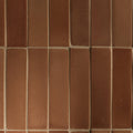 Reddish-brown glossy tan ceramic bricks with visible mortar lines ideal for decorative wall applications