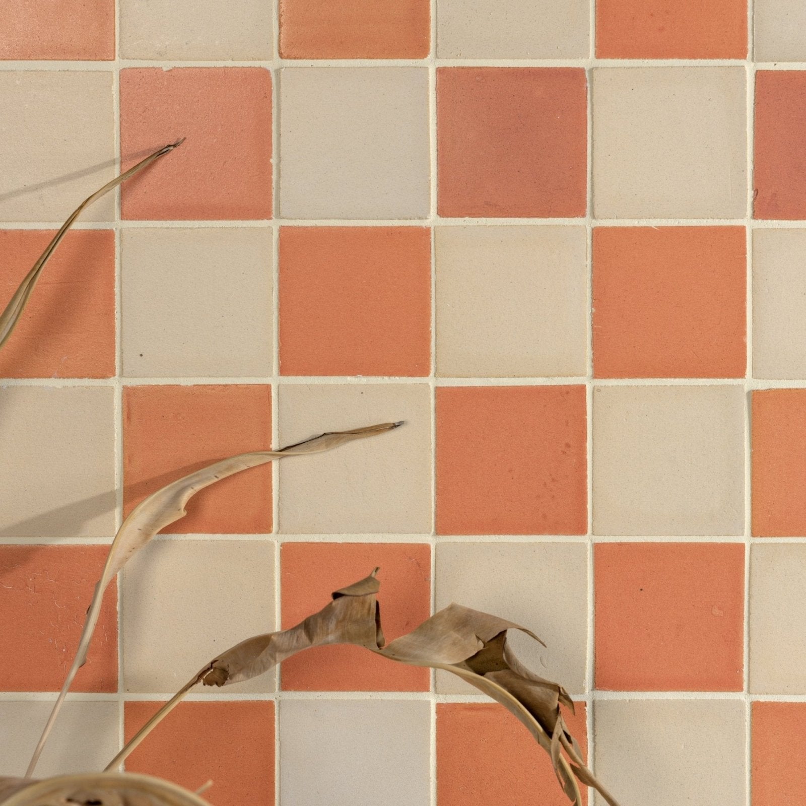 Stone glaze ceramic terra matt square tiles in coral and off-white arranged in a checkerboard pattern