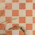 Stone glaze ceramic terra matt square tiles in coral and off-white arranged in a checkerboard pattern