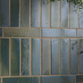 Stone glaze ceramic winter pond gloss brick tile with blue green textured ceramic arranged in a brick pattern with beige grout