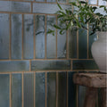 Blue-green glazed ceramic tiles with a textured rustic finish arranged in vertical rows from stone glaze ceramic winter pond gloss brick
