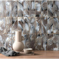 Cream-colored ceramic vase with two handles and rounded body featuring storm patterned brick design