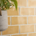 A hanging concrete planter with a textured matte gray finish and woven rope handle for straw half tile wall tiles