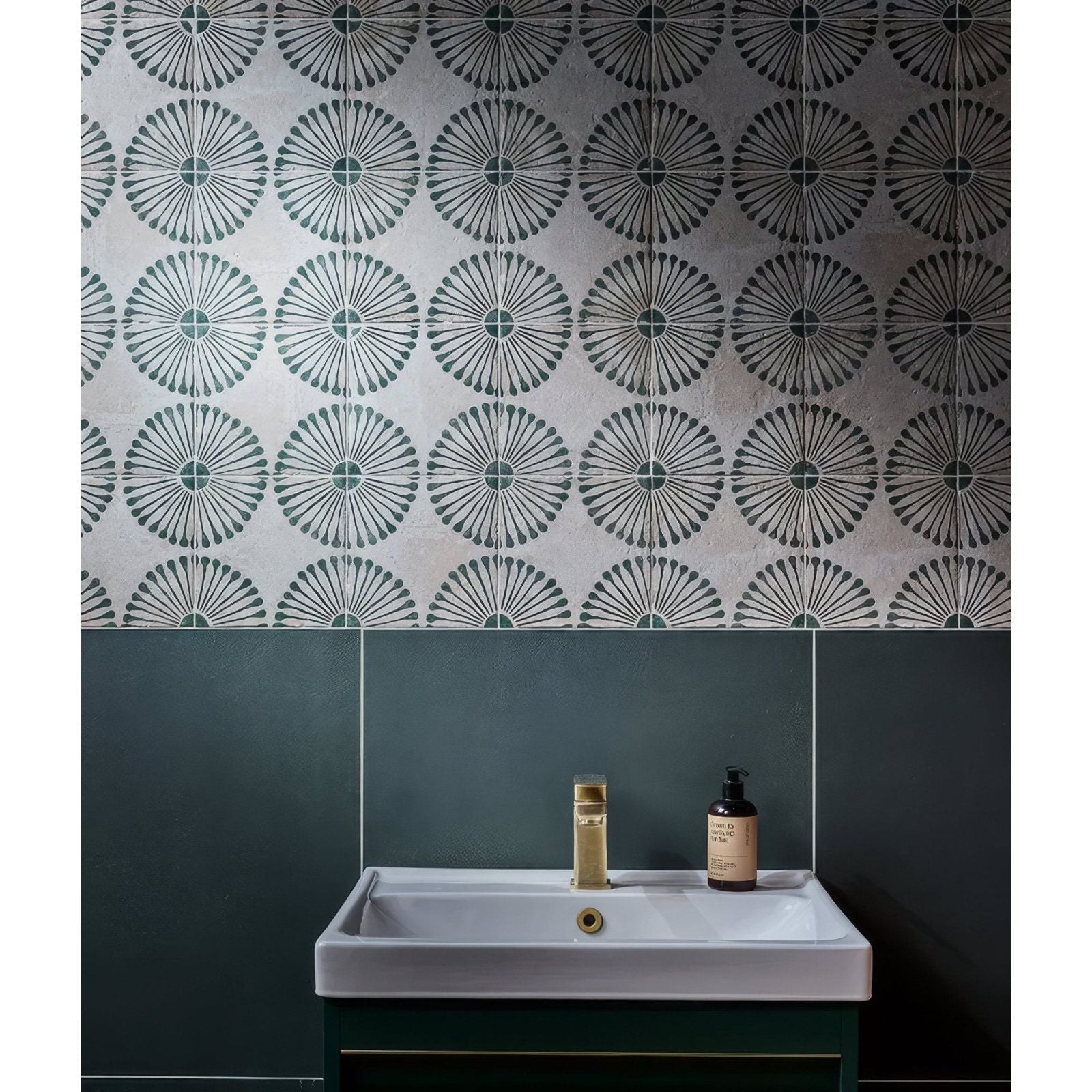 White rectangular stucco porcelain textured sink with gold faucet above dark green cabinet in bathroom setting