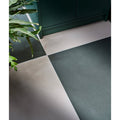 Stucco porcelain textured green floor tiles in dark green and light gray matte finish with geometric pattern