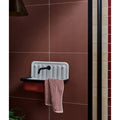 White enamel wall-mounted stucco porcelain textured red sink with black faucet and vertical ridges on back panel