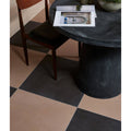 Black and beige checkered stucco porcelain textured umber floor tiles showing their durable textured surface
