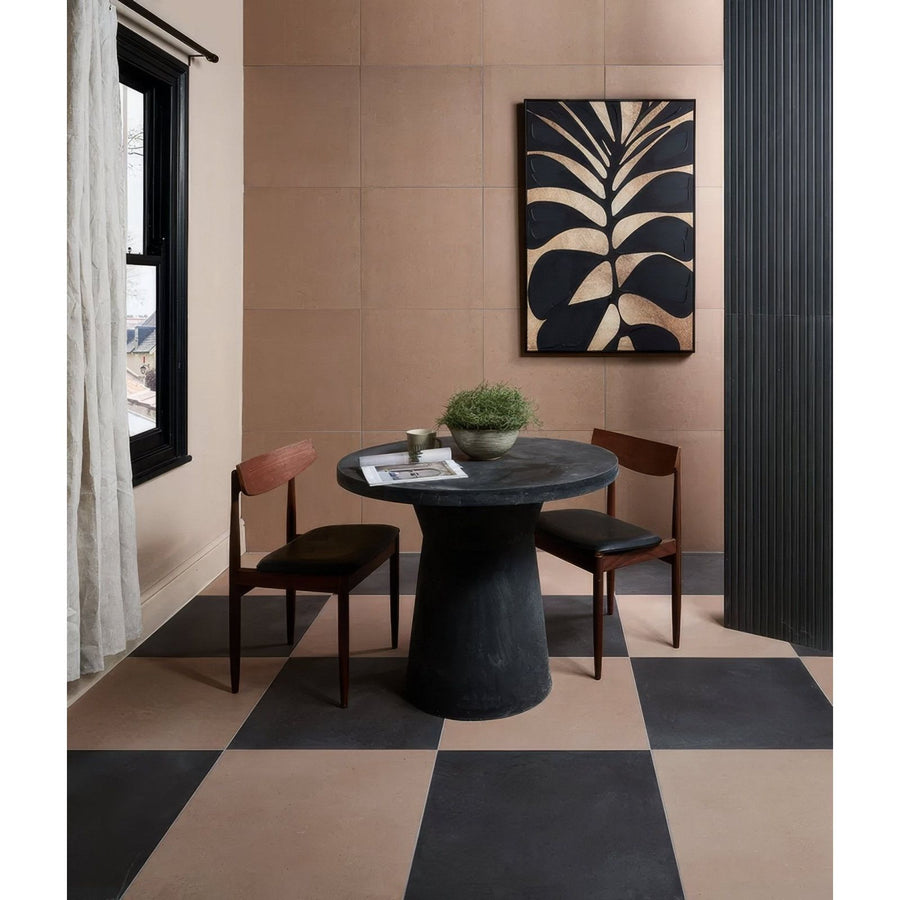 Black stone pedestal table with round top and minimalist design in stucco porcelain textured umber finish