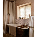 Antique-style black Studio Abbey Red Ceramic bathtub with white porcelain interior and wooden tray on its edge