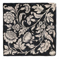 Black square scarf featuring intricate white floral and leaf patterns in a vintage studio assisi blue ceramic design