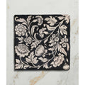 Black ceramic tile studio assisi blue featuring intricate white vintage hand-painted floral and leaf patterns