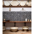 Black and white floral patterned ceramic tiles with intricate repeating designs from Studio Assisi Blue Ceramic