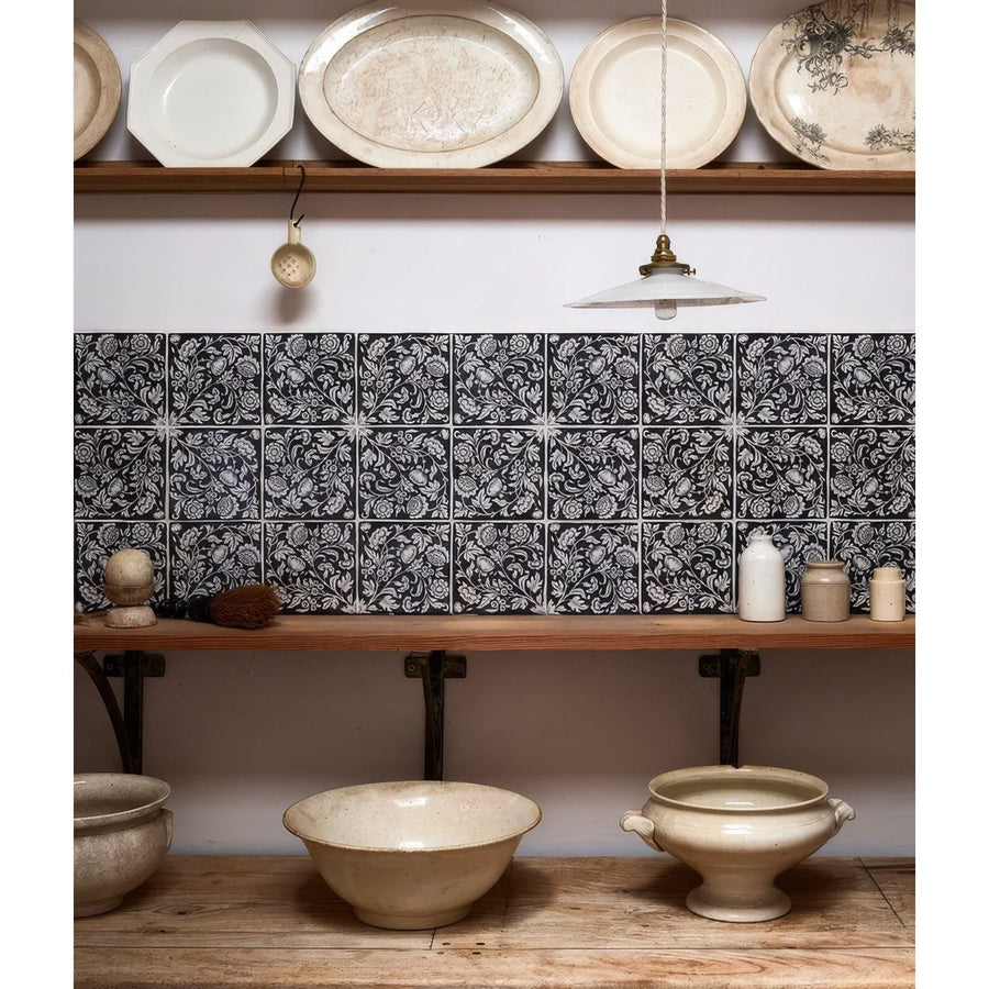 Black and white floral patterned ceramic tiles with intricate repeating designs from Studio Assisi Blue Ceramic