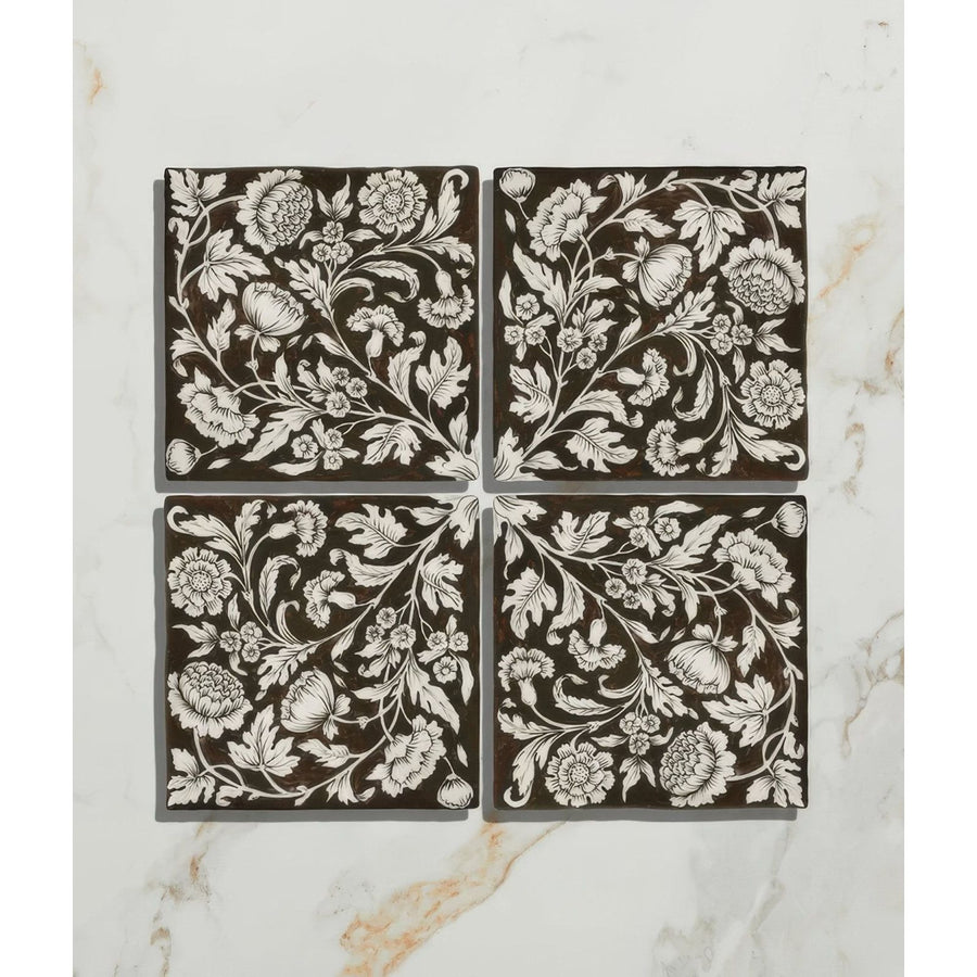 Set of four brown ceramic coasters with intricate white floral and botanical patterns from Studio Assisi brown ceramic