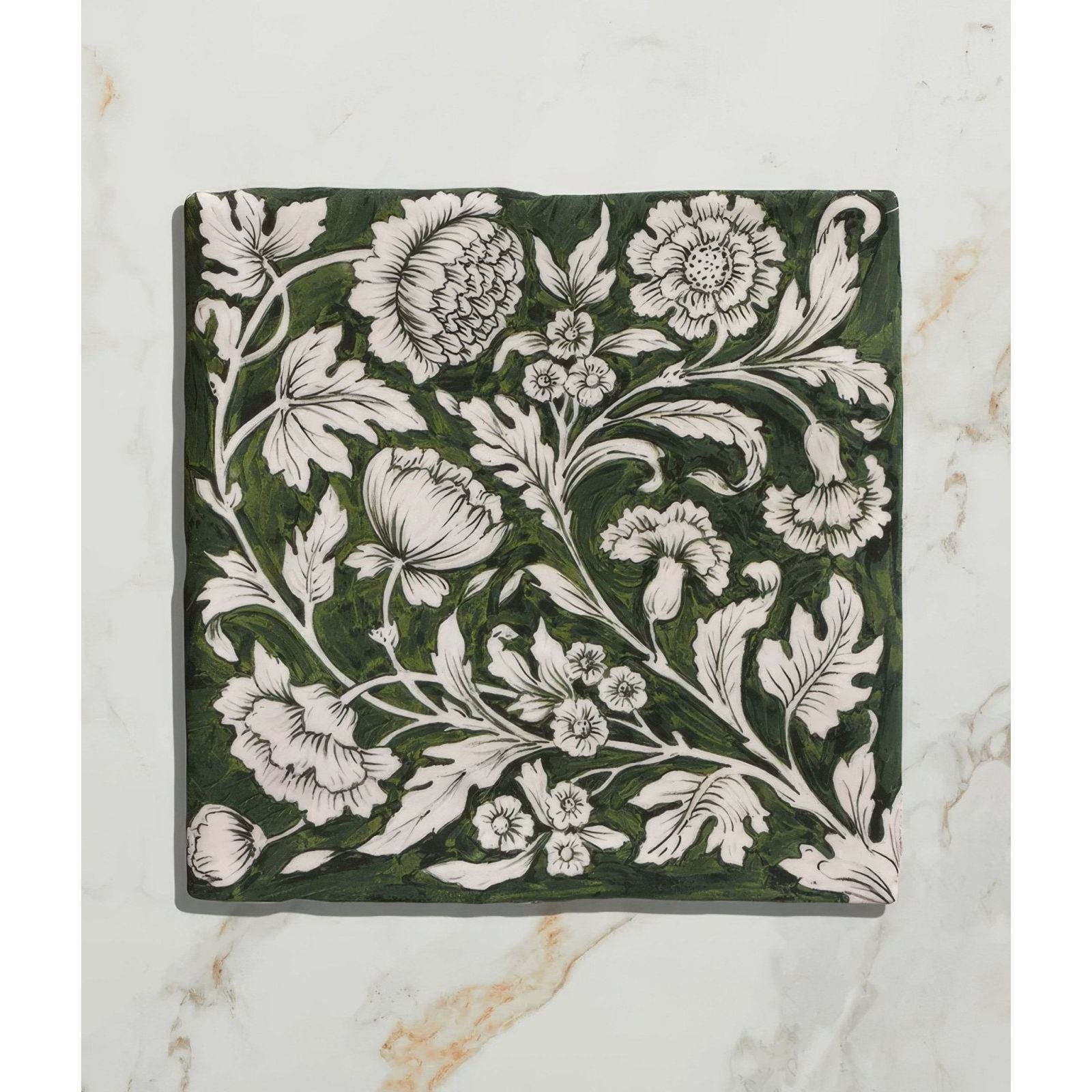 Studio Assisi Green ceramic tile in dark green with intricate white floral and leaf patterns in vintage hand-painted style