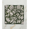 Studio Assisi Green ceramic tile in dark green with intricate white floral and leaf patterns in vintage hand-painted style
