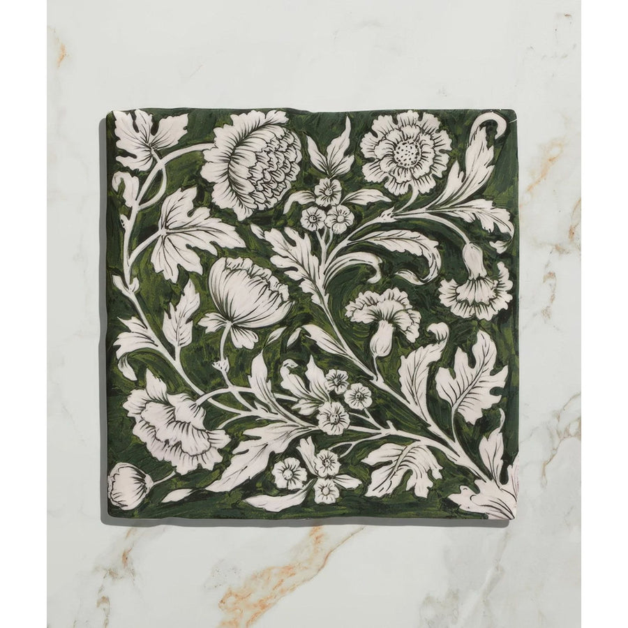 Studio Assisi Green ceramic tile in dark green with intricate white floral and leaf patterns in vintage hand-painted style
