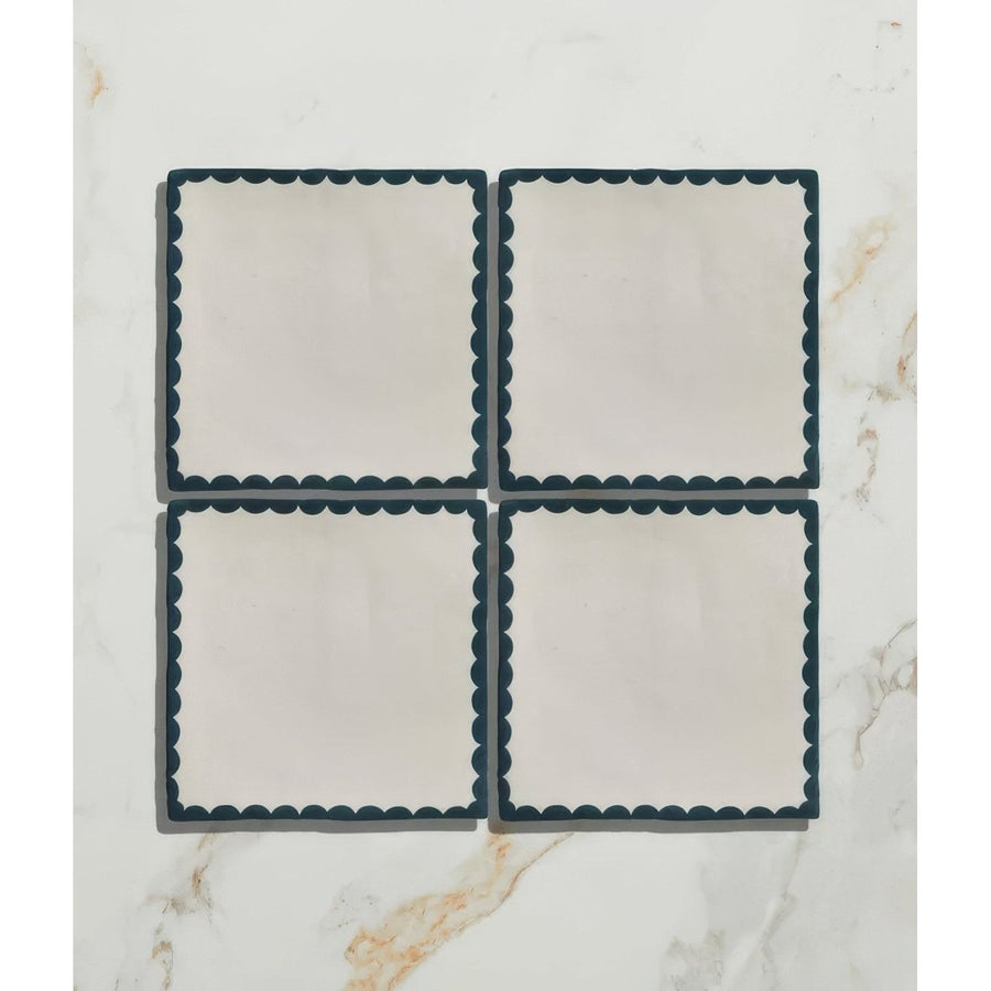 Set of four cream ceramic coasters with dark teal scalloped edge from Studio Bobbin Ceramic Blue collection