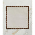 Square ceramic plate by Studio Bobbin with cream center and dark brown scalloped border for serving chocolate