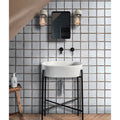 White oval ceramic sink on a black metal stand from studio bobbin ceramic chocolate collection